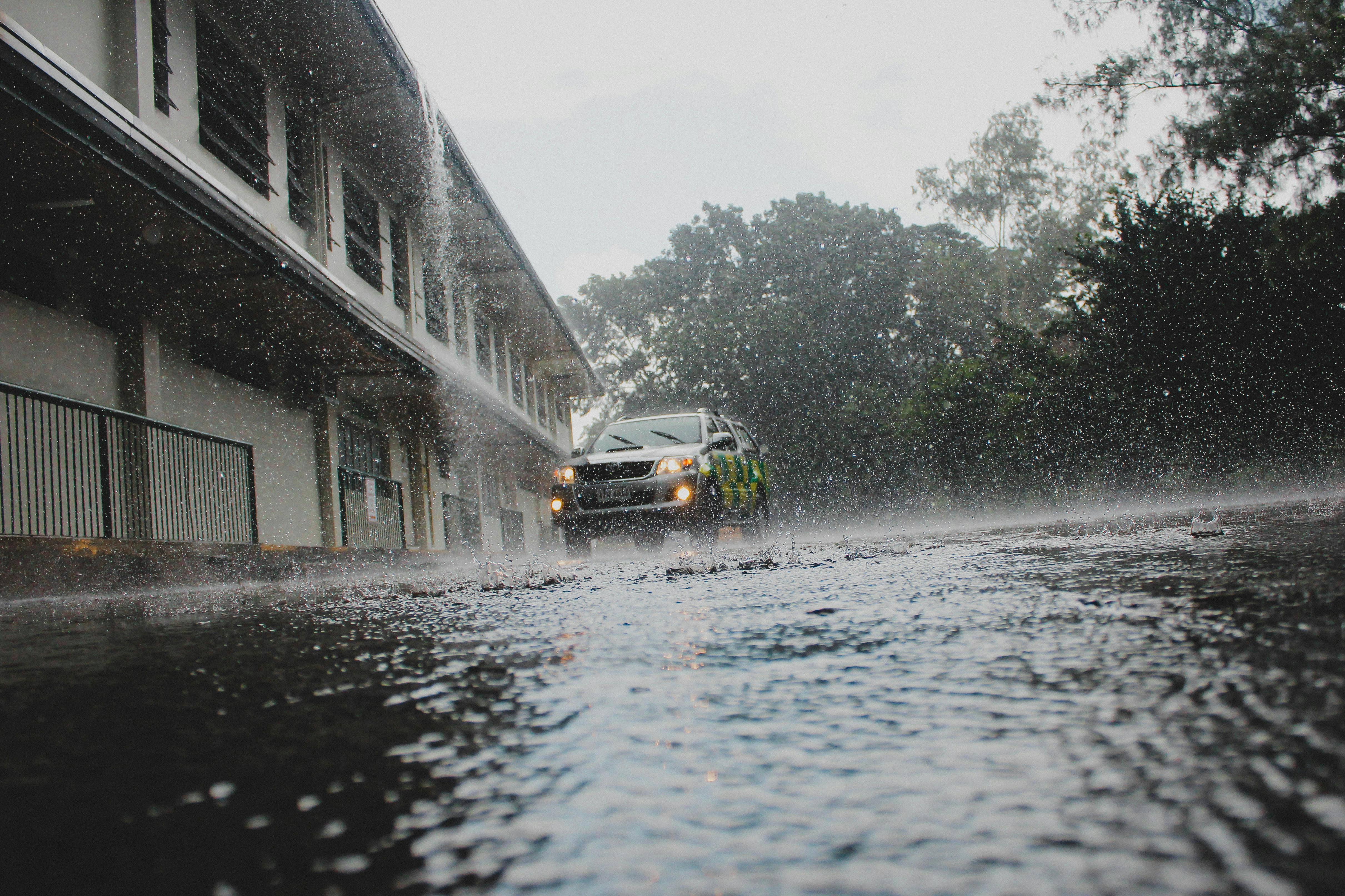 Car driving in rain and flood.