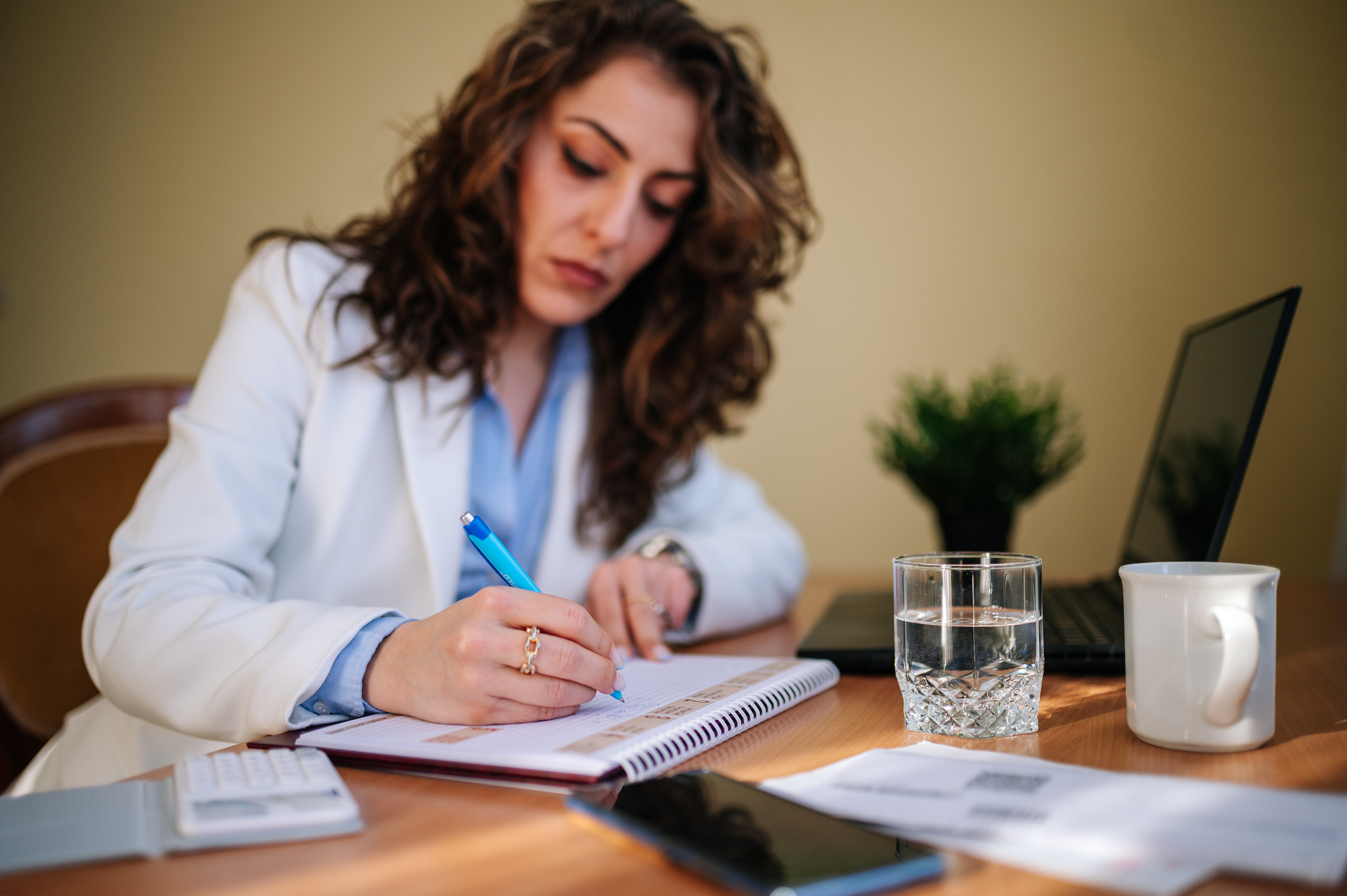 Woman writing at a desk.